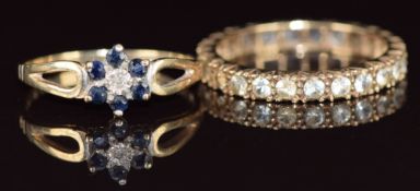 A 9ct gold eternity ring and a 9ct gold ring set with a diamond surrounded by sapphires, 4.2g,