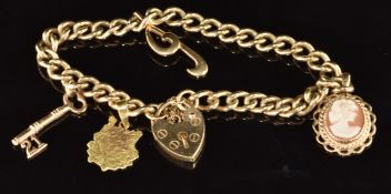 A 9ct gold charm bracelet with three 9ct gold pendants / charms including cameo, letter 'g' and a