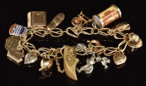 A 9ct gold charm bracelet with eleven 9ct gold charms including police helmet, shoe, bible, bag, etc