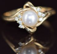 A 9k gold ring set with a cultured pearl and diamonds, 2.8g, size R