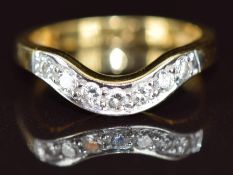 An 18ct gold ring set with diamonds in a curved setting, size N