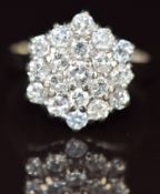 An 18k gold ring set with round cut diamonds in a hexagonal cluster, the total diamond weight