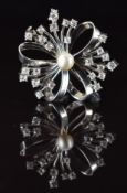 A platinum pendant / brooch set with a pearl and diamonds, 13.6g, 3.2cm