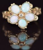 A 9ct gold ring set with opal cabochons and a diamond in a flower cluster, 3.6g, size P