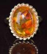 A 9ct gold ring set with an amber cabochon, 3.2g, size N