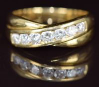 An 18ct gold ring set with seven round cut diamonds from approximately 0.08ct to 0.12ct in a cross