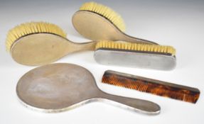 Art Deco style hallmarked silver dressing table set comprising hand mirror, three brushes and a