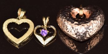 Three 9ct gold heart pendants, one rose gold, one set with an amethyst and the other with textured