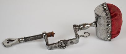 Early 19th century cut steel sewing clamp with pin cushion top and screw clamp mechanism, length