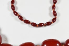 Cherry amber necklace made up of 50 graduated oval beads, the smallest 6.6 x 10.8mm and largest 21.2