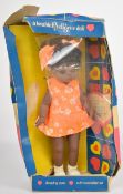 Pedigree Cleo Walker doll with black hair, brown weighted eyes, orange dress and matching