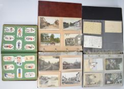 Two albums of mainly Edwardian postcards including humorous, sentimental, topographical,