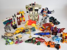 A collection of vintage Hasbro / Takara Transformers action figures and vehicles