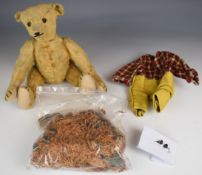 Early 20th century Steiff Teddy bear with stuffed body, jointed limbs, blonde mohair, black eyes and