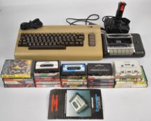 Commodore 64 retro gaming system together with power supply, cassette deck, joystick and a