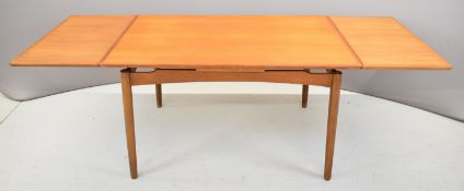 Retro mid century modern teak draw leaf table with two additional leaves, raised on turned legs,