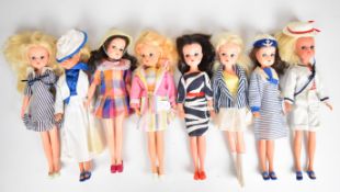Eight vintage Sindy dolls by Pedigree dressed in 1980's outfits to include Ahoy There, Check Mate,