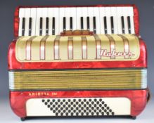 Hohner Arietta IM 36 key piano accordion in red and gold, with leather strap and hard carry case.