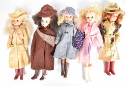 Five vintage Sindy dolls by Pedigree dressed in 1980's Autumnal outfits including hats, scarves,