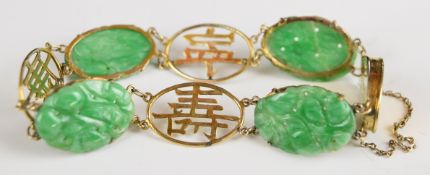A 9k gold Chinese bracelet set with carved jadeite panels and pierced character links, 12.1g