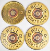 A set of five place mats in the form of Hull and Eley shotgun cartridge ends, each 28cm in diameter.