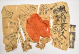 Japanese flag in fragile condition, with two photographs of a Japanese soldier