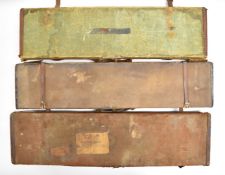Three vintage leather and canvas bound shotgun carry cases, one with 'Army & Navy Co-operative