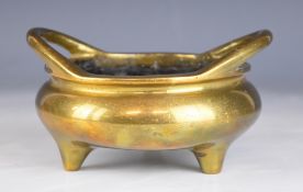Chinese bronze twin handled censer with six character mark to base, raised on three feet, width
