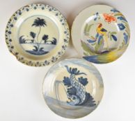 Three 18thC Delft plates including a polychrome example with exotic bird decoration, largest
