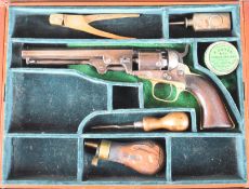 Colt .31 five-shot single-action revolver with brass trigger guard and grip strap, shaped wooden