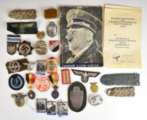 Mainly reproduction German WW2 Nazi insignia, booklets etc