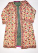 19th / 20thC Indian embroidered coat or coat dress, with a note stating the coat was gifted in the