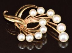 A 14k gold Mikimoto brooch set with cultured pearls, 5.2cm, 12.1g