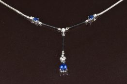 An 18ct white gold necklace set with three pear cut sapphires and diamonds, the total sapphire