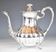Elizabeth II hallmarked silver coffee pot of lobed form, raised on four feet, the spout having