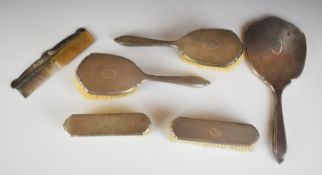 Art Deco hallmarked silver mounted dressing table set comprising hand mirror and four brushes,