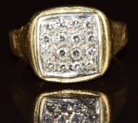 An 18ct gold ring set with diamonds in a square setting, 6g, size G