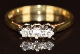 An 18ct gold ring set with three diamonds in a platinum setting, 3.1g, size N