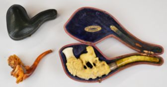 Two cased Meerschaum pipes comprising an erotic example with figurehead holding her bosom and Baltic