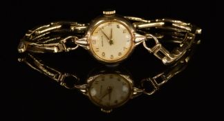 Marvin 9ct gold ladies wristwatch with gold hands and Arabic numerals, silver dial and signed
