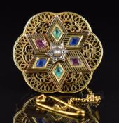 An 18ct gold c1900 pierced brooch set with a split pearl, rose cut diamonds, spinel and paste, 13.