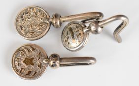 Three Victorian and later hallmarked silver napkin clips or holders including a Scottish example,