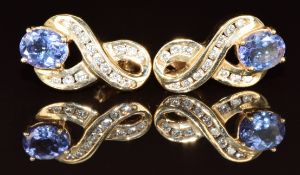 A pair of 14k gold earrings each set with an oval cut tanzanite of approximately 0.5ct and diamonds,