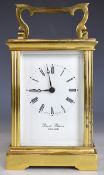 David Peterson gilt metal cased carriage clock with white painted dial, striking on a bell, height