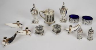 Silver condiments comprising hallmarked silver four piece cruet set with blue glass liners, pair