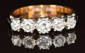 An 18ct gold ring set with five diamonds in a platinum setting, 3.1g, size L