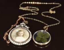 A 9ct gold pendant set with a four leaf clover and an Edwardian silver locket set with paste and a