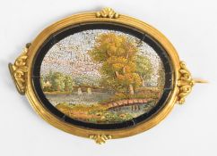 Victorian yellow metal brooch set with a micro mosaic depicting a river and bridge