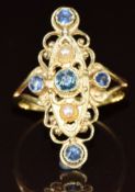 An 18k gold ring set with spinel and pearls in a pierced marquise setting, 3.3g, size M