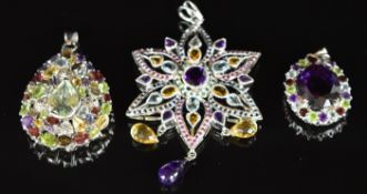 Three silver pendants set with amethysts, peridiot, garnets, topaz, citrine, rubies, sapphires and